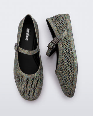 Top and side view of a pair of dark silver glitter Harper flat with strap