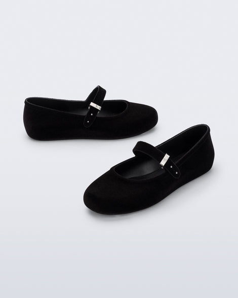 Side and angled view of a pair of black Soft Ballerina Velvet II flats