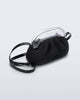 Angled view of a small black bag with clear clutch and long strap
