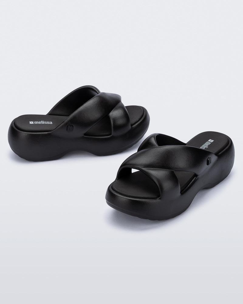 Side and angled view of a pair of black Free Rise platform slide