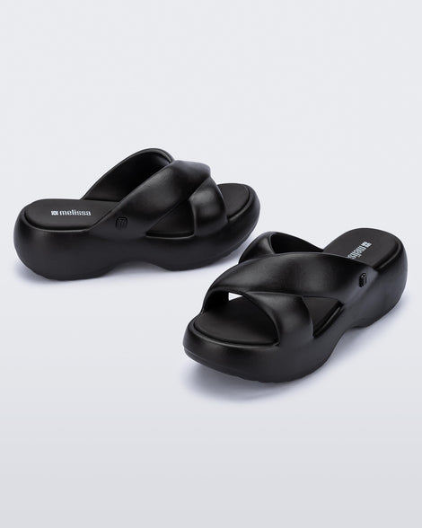 Side and angled view of a pair of black Free Rise platform slide
