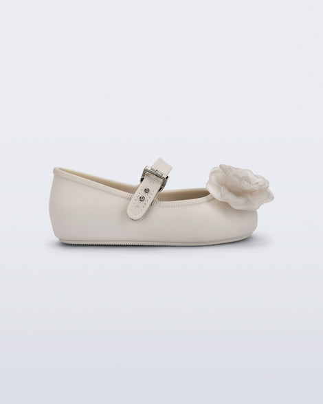 Side view of a beige Soft Ballerina baby flat with beige flowers