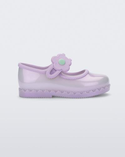 Side view of a pearly lilac Hip Ballerina baby flat with strap with flower