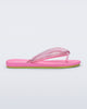 Side view of a pink Flip Flop Airflow sandal with a clear pink strap and green bottom