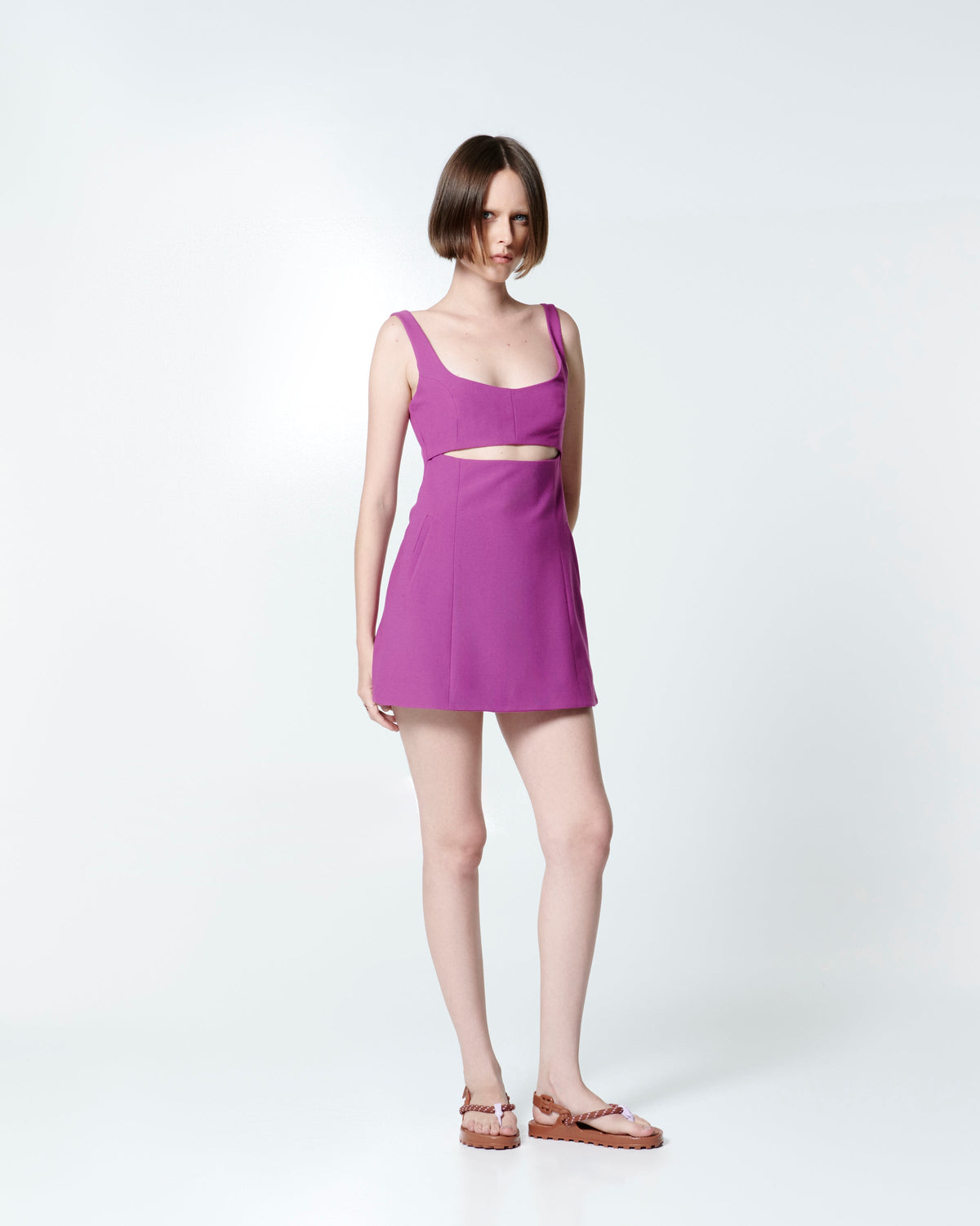 Model in a fuchsia dress wearing a pair of brown Bond sandals with textile strap and purple toe piece
