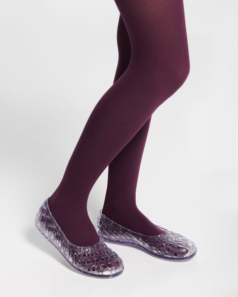 Model's legs in purple tights wearing a pair of clear Possession Ballerina flats
