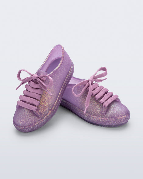 Angled view of a pair of glitter lilac kids Hip Sneakers with lilac laces