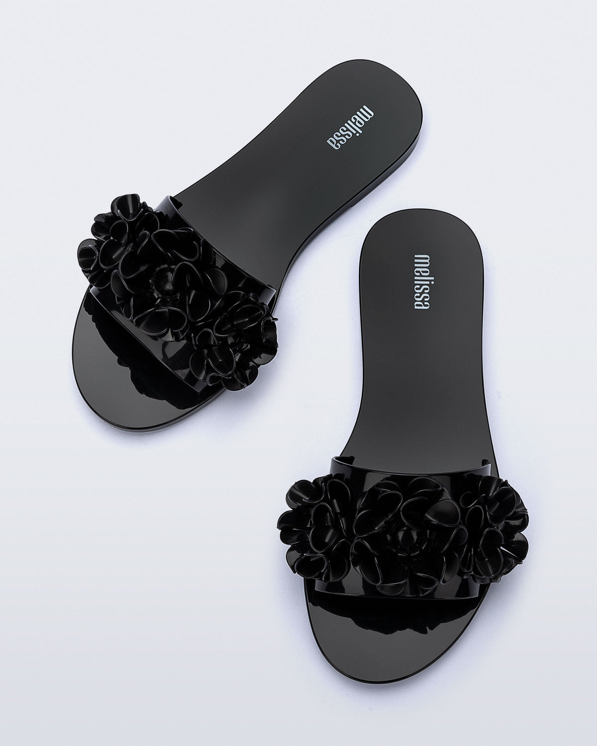 Top view of a pair of black Babe Springtime slides.