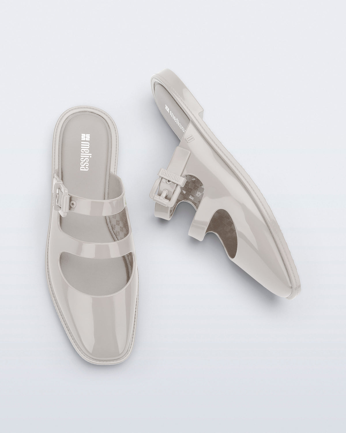 Side and top view of a pair of beige Anastasia mule slides