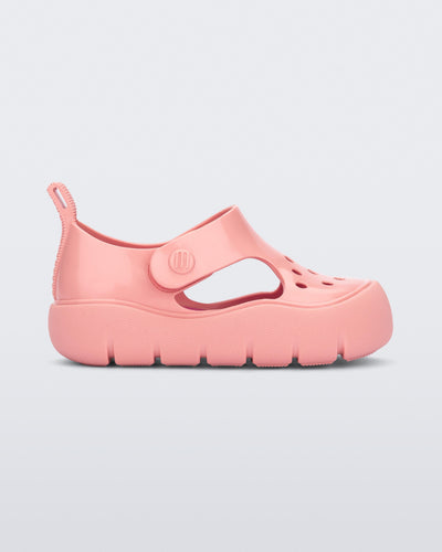 Side view of a pink Bowie baby sandal.