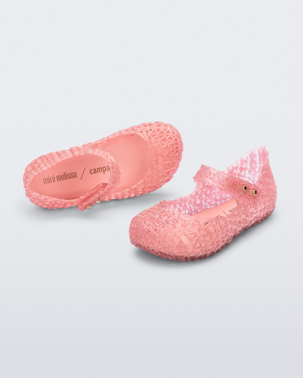 Top and angled view of a pair of pearly pink baby Campana flats