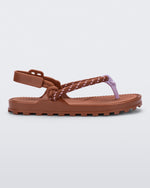 Side view of a brown Bond sandal with textile strap and purple toe piece