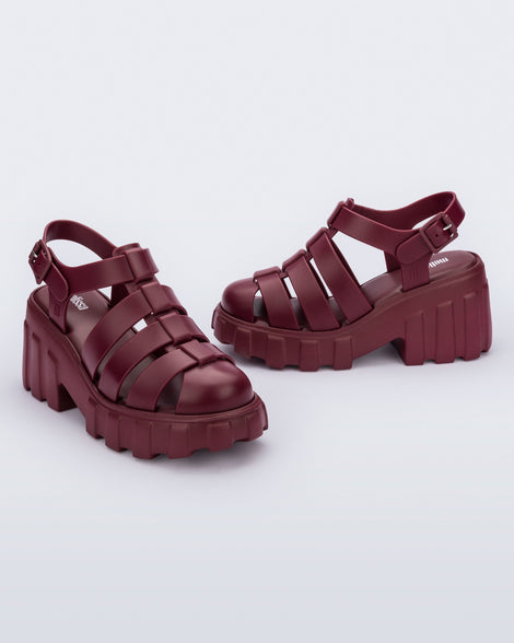Side and angled view of a pair of red Megan platform fisherman style adult sandal
