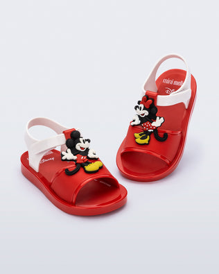 Angled view of a pair of red  Play Mickey & Minnie sandals with white straps