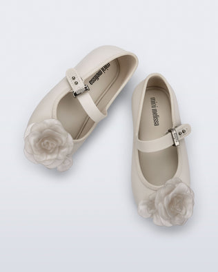 Top view of a pair of beige Soft Ballerina baby flats with beige flowers