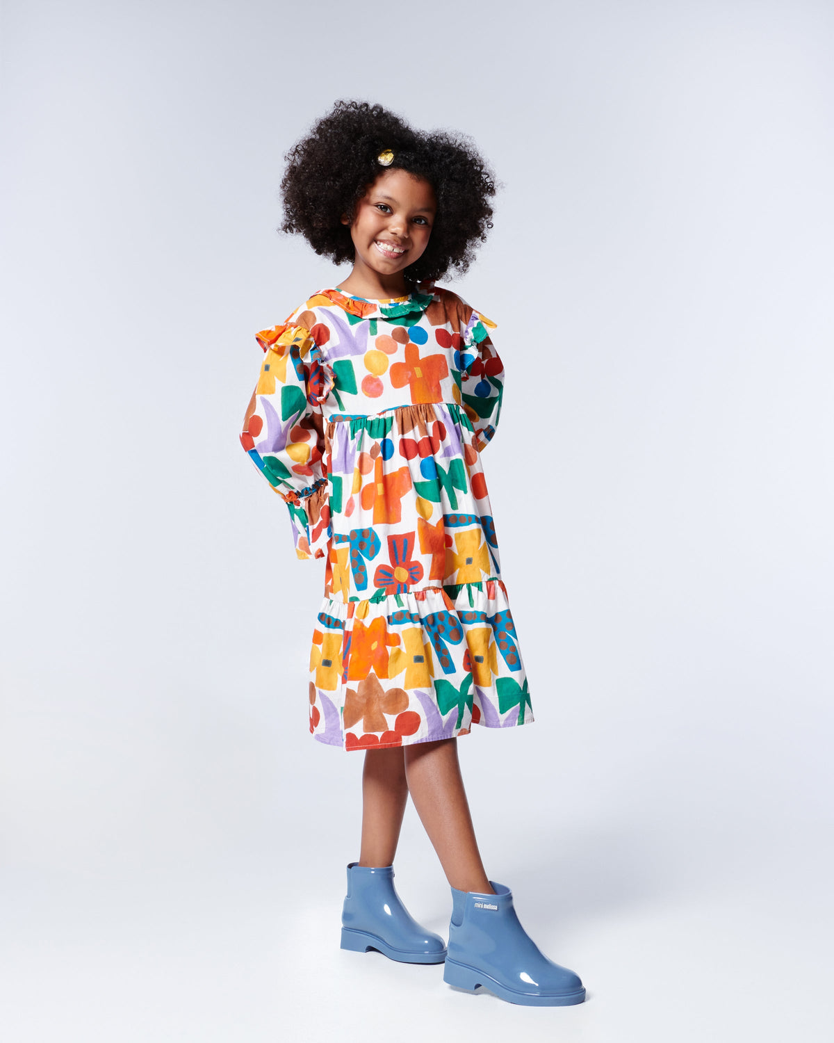 Model in patterned dress wearing a pair of blue Chelsea II kids boots