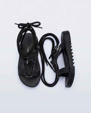 Side and top view of a pair of black Kirk + Alexandre Pavao sandals with ankle strap