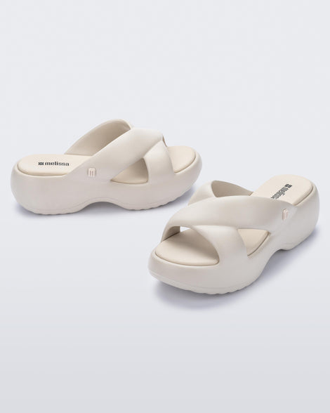 Side and angled view of a pair of beige Free Rise platform slide