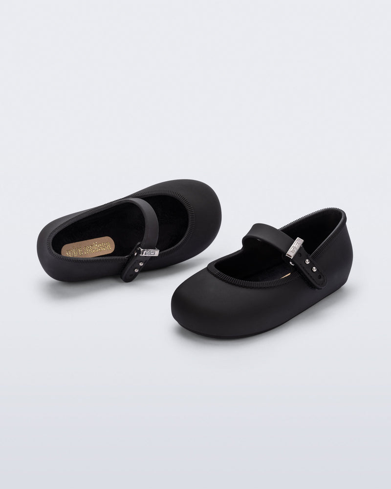 Top and side angled view of a pair of black Soft Ballerina baby flat with Velcro strap