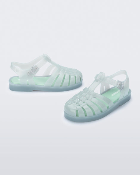 Side and angled view of a pair of light green kids Possession sandals.