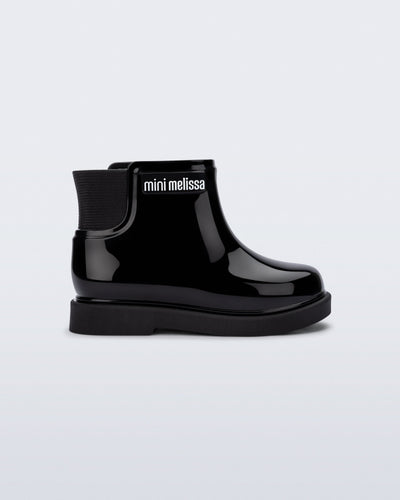 Side view of a black Chelsea II baby boot