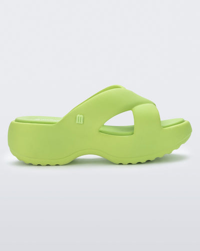 Side view of a green Free Rise platform slide sandal