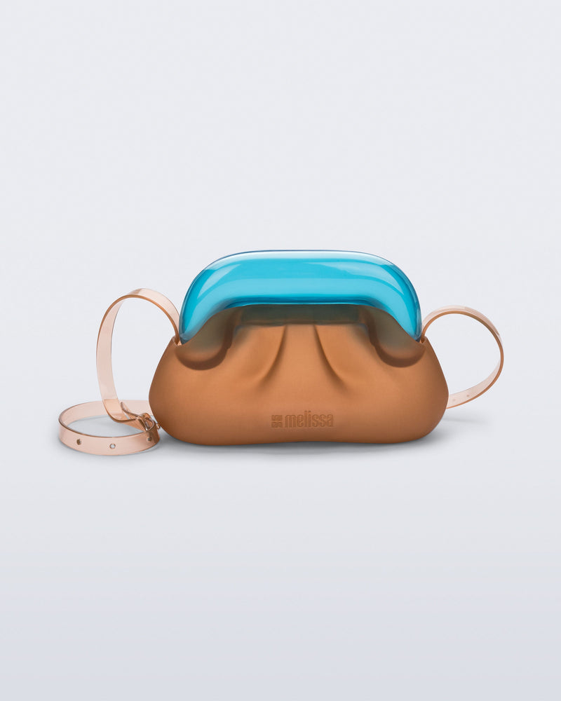 Front view of a small clear orange bag with blue clutch and long strap