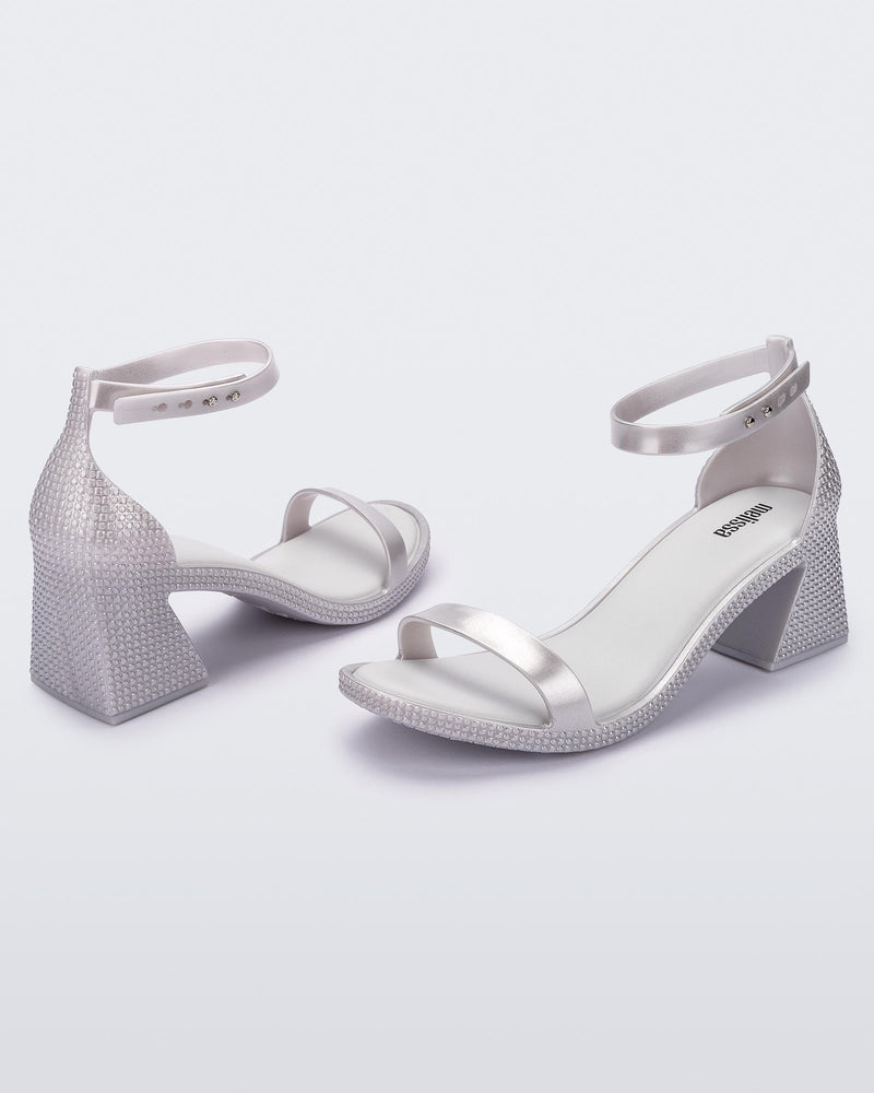 Angled view of a pair of metallic silver Lux Heels