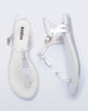 Side and top view of a pair of pearly white Solar M Chic sandals