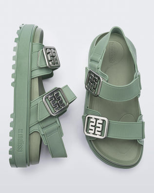 Side and top view of a pair of green Towny sandals with straps and silver buckle