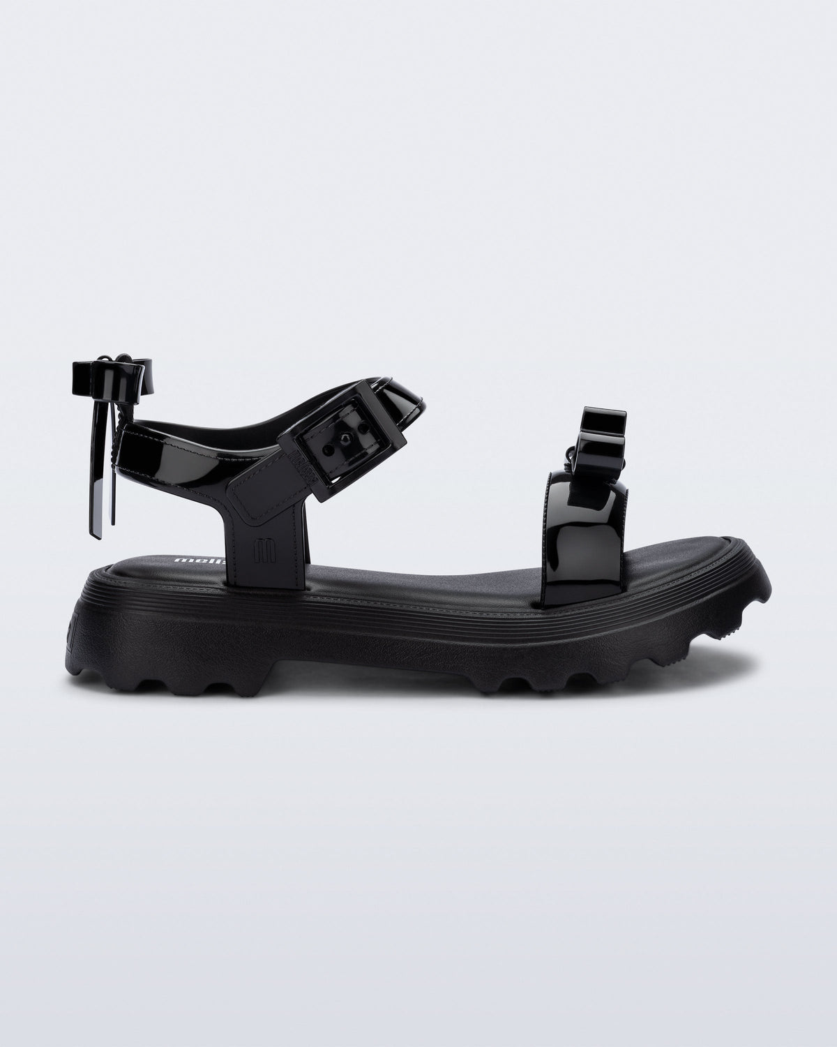 Side view of a black Town Bow sandal