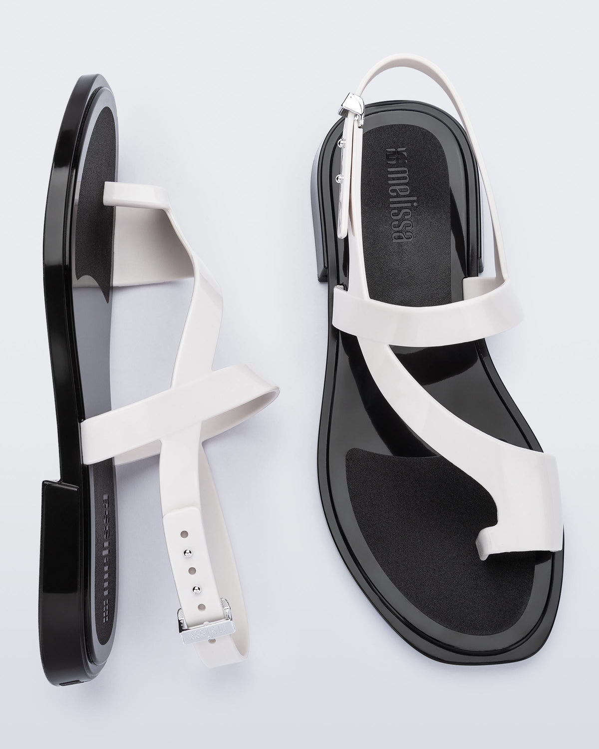 Top and side view of a pair of white Cassie sandals.