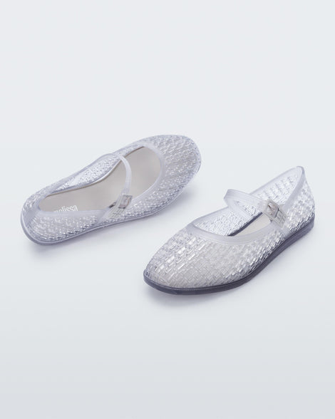 Top and angled view of a pair of clear Harper ballet flats with top strap with buckle
