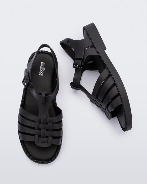 Top and side view of a pair of matte black Possession Fresh fisherman style sandals with open toe.