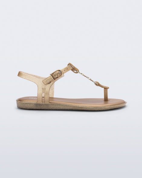 Side view of a gold glitter Solar kids sandal