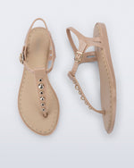 Top and Side view of a pair of beige Solar Boho t-strap sandals with ,metallic detailing on the front strap