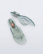 Top and side view of a pair of transparent green Flip Flop + Diesel sandals