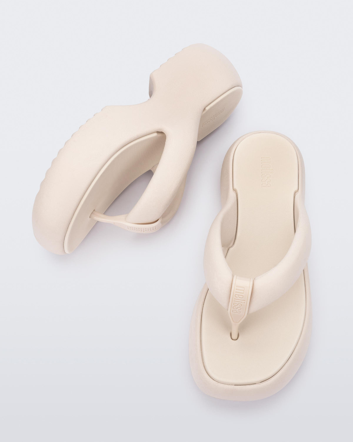 Side and top view of a pair of beige Free Platform II flip flops