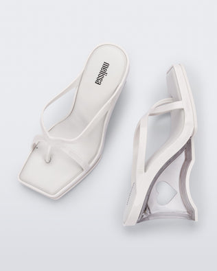 Side and top view of a pair of white Glass Heels with a heart cutout in the heel.