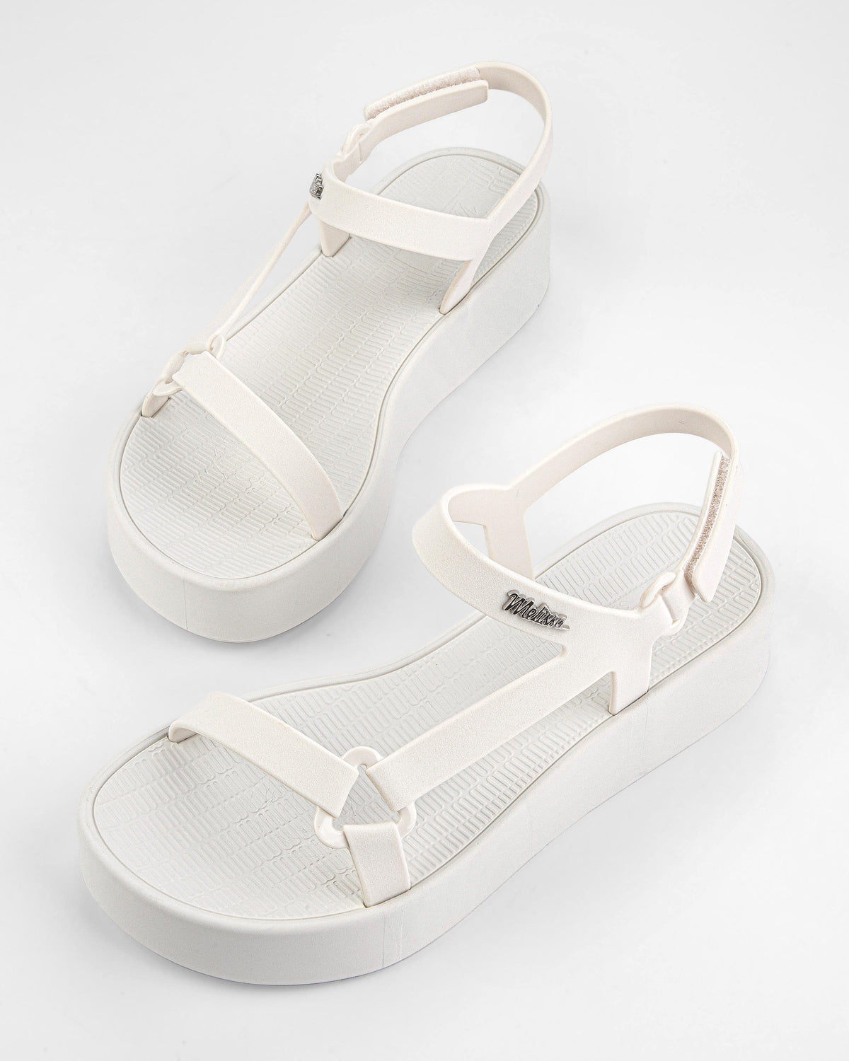 Top angled view of a pair of white Sun Downtown Platform sandals