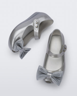 Top and side view of a pair of pearly silver Ultragirl Sweet baby ballerina flats