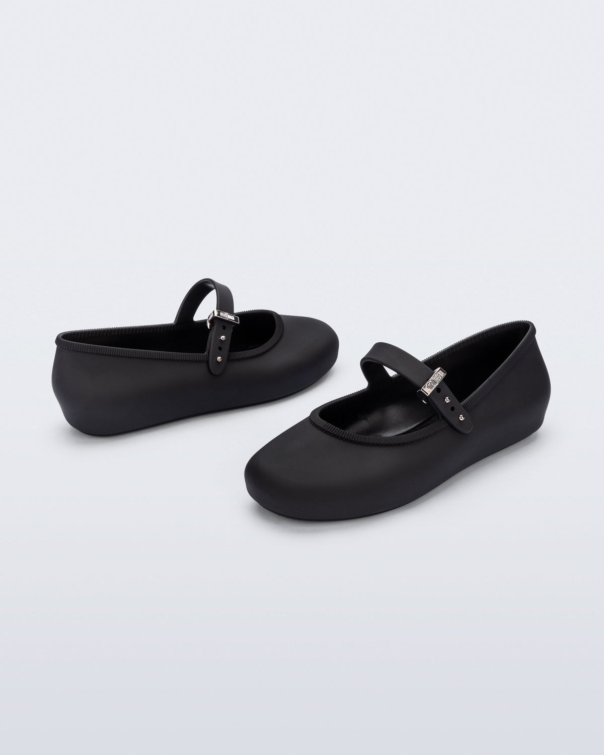 Back and side angled view of a pair of black Soft Ballerina kids flat with strap