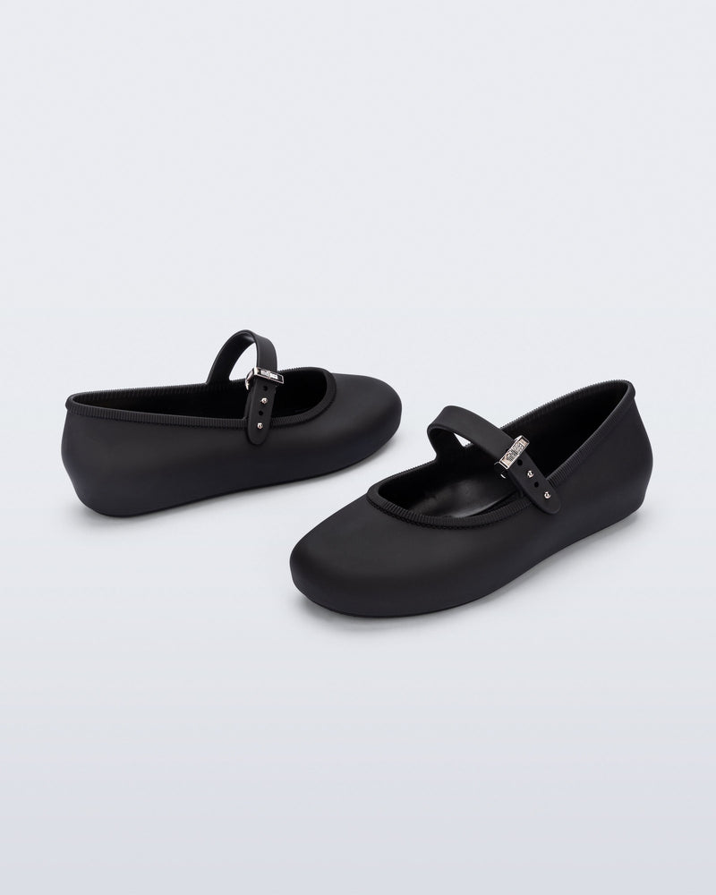 Back and side angled view of a pair of black Soft Ballerina kids flat with strap