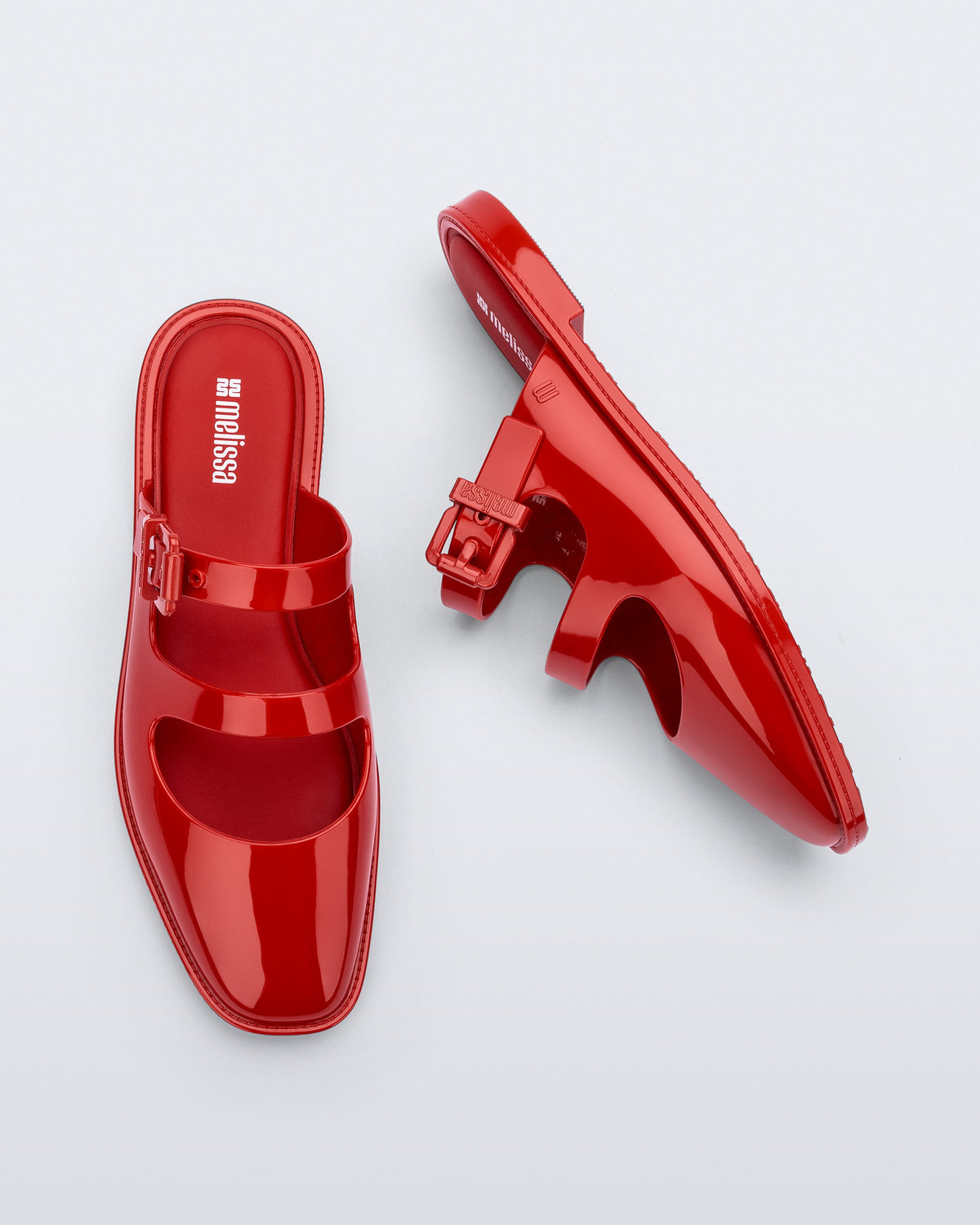 Side and top view of a pair of red Anastasia mule slides