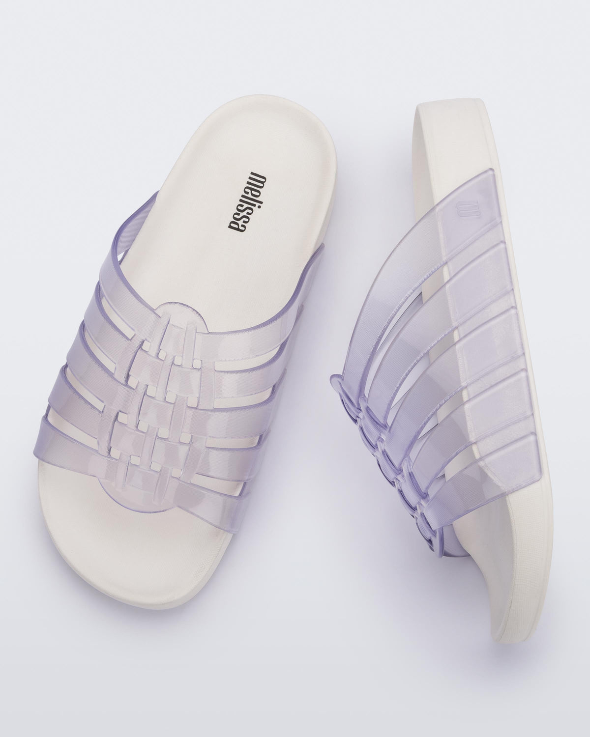 Top and side view of a pair of clear Possession Slide with white sole