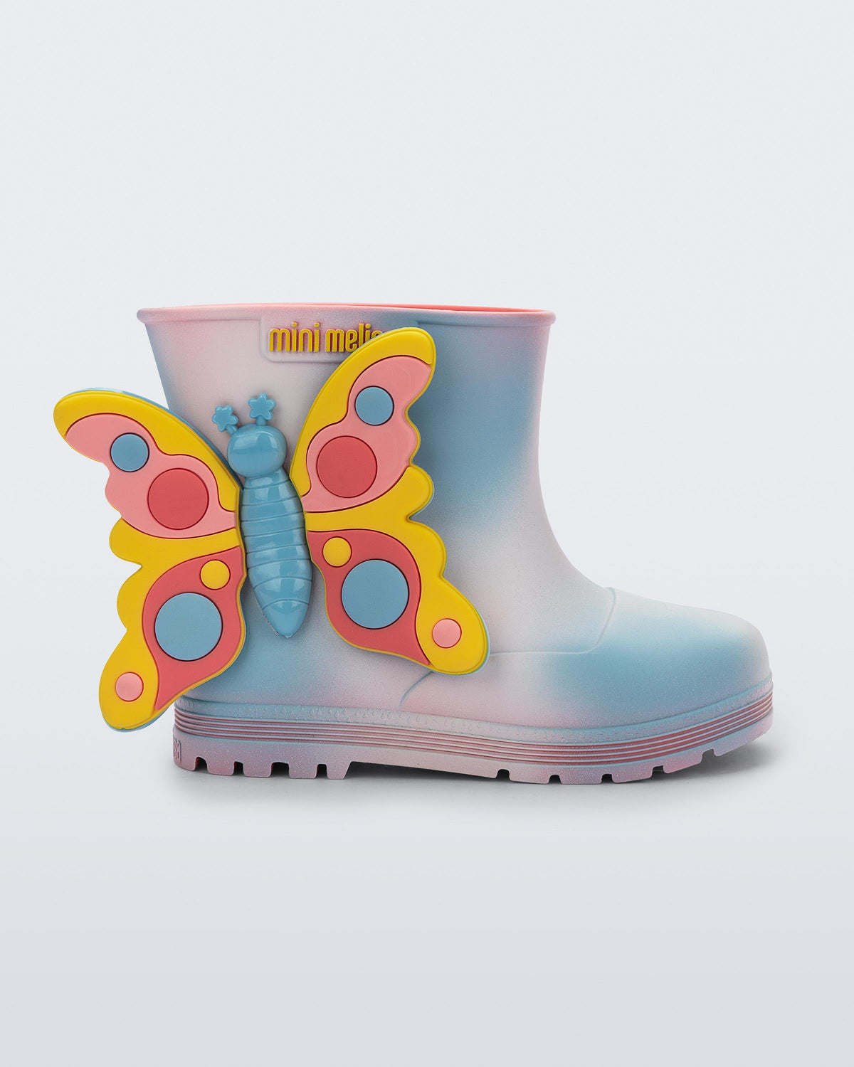 Side view of an pink with blue splotches Welly Wonderland baby boot with yellow/blue butterfly on side