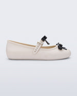 Side view of a beige Soft Ballerina Bow with black bows and a pearl in the center of each bow