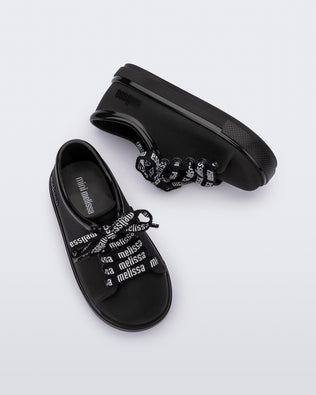 Top and side view of a pair of black baby Hip M Lover sneakers with laces