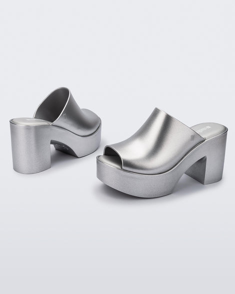 Angled view of a pair of light silver Mule Hype Platforms