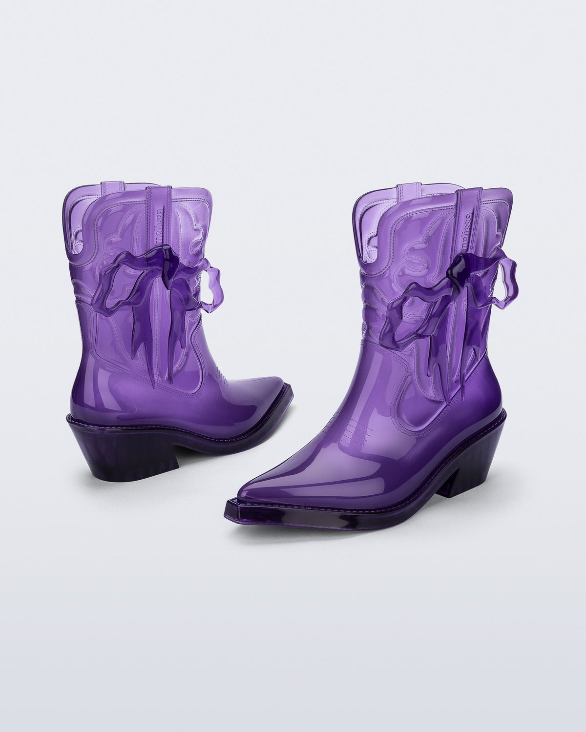 Front and back angled view pf a pair of transparent Purple Texas + Maldito boots
